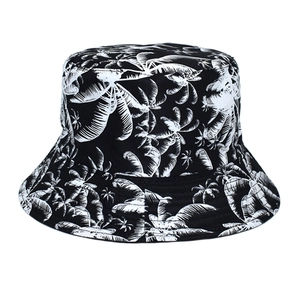 Close-up of black and white tropical palm leaf print on a breathable cotton bucket hat