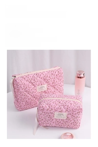 Detailed macro view of two-piece pink floral quilted makeup bags with secure zipper closure