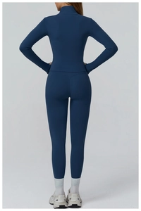 Rear view of slim fit dark blue long-sleeved yoga top and high-waisted leggings set