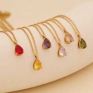 Golden necklace with pear-cut colorful gemstone pendants in various vibrant colors