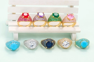 Macro detail of hip hop rings with large colorful zircons and full pave settings