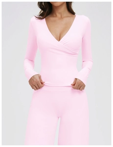 Detailed front view of pink V-neck long-sleeve top and high-waist yoga leggings set