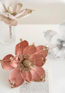 Macro shot of 20cm dusty pink magnolia with gold glitter edges for Christmas decor