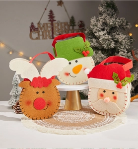 Three festive felt Christmas gift bags featuring reindeer, snowman and Santa Claus designs