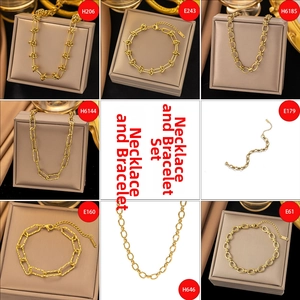 Macro view of 18K gold plated minimalist necklace and bracelet jewelry sets in a display box