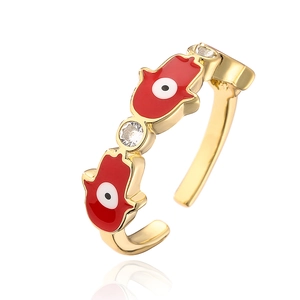 Close-up of 18K gold plated Hamsa Hand ring with red enamel and zircon stones