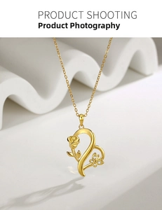 Macro view of gold S925 silver heart necklace with rose and butterfly pendant details