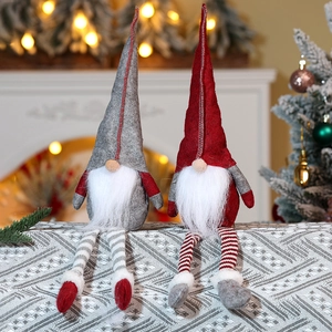 Detail of red and grey Christmas gnome dolls with long legs and knitted pointed hats