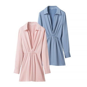Detail of pink and blue satin V-neck dresses with elegant pleated waist and long sleeves