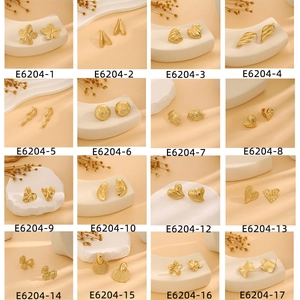 Collection of gold earrings with heart floral and geometric textures in 4x4 grid layout