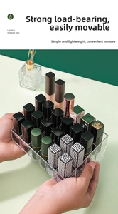 Handheld view of a clear acrylic lipstick organizer with 24 slots for desktop storage