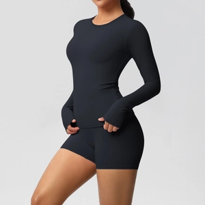 Close-up of black yoga set with thumbhole sleeves and high-waisted fitness shorts
