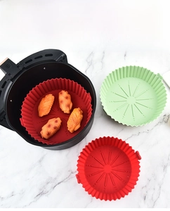 Silicone air fryer liner with wavy edges and drainage lines for baking chicken wings