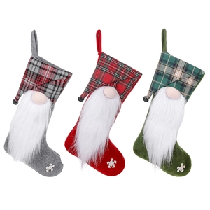 Three Christmas stockings with gnomes and plaid patterns for festive tree decoration