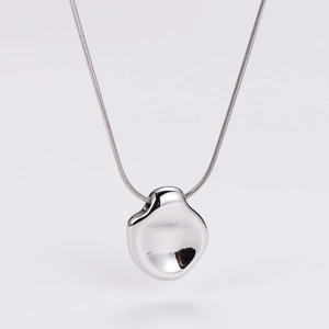 Macro view of irregular organic pendant with high-mirror finish on fine snake chain
