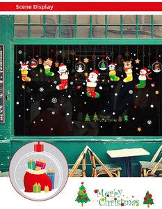 Detailed view of Christmas window decals featuring Santa and reindeer in holiday socks