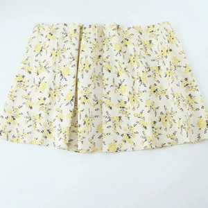Pale yellow floral poplin midi skirt with elegant black leaf and yellow flower prints