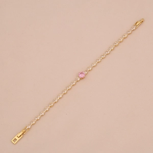 Elegant gold bracelet featuring a round pink crystal pendant on a delicate chain