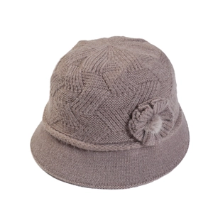 Women's warm winter knitted bucket hat in beige with floral accent and soft pom-pom
