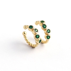 Gold beaded ear cuff set featuring five round green gemstones on a white background