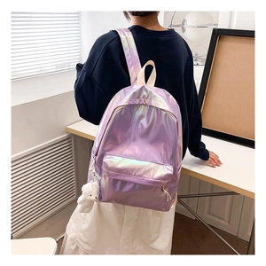 Back view of a laser purple holographic backpack with a white plush bear charm