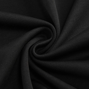 Macro shot of black pleated fabric texture with elegant spiral patterns and smooth finish