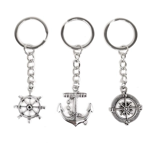 Vintage nautical keychain set with silver anchor, ship wheel and compass pendants