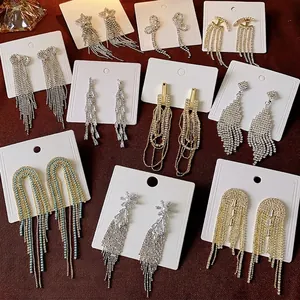 Sparkling long tassel drop earrings set with crystals and star patterns on white cards