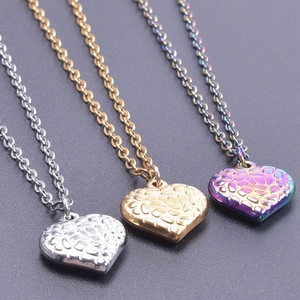 Macro detail of gold, silver, and purple heart pendants with unique textured surface