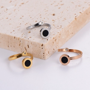 Detail view of Roman numeral stainless steel rings with black enamel and zircon inlay