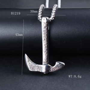 Detail view of 30x43mm stainless steel axe pendant with hammered texture and snake chain