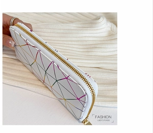 Detail of colorful geometric pattern and golden zipper on white leather long wallet