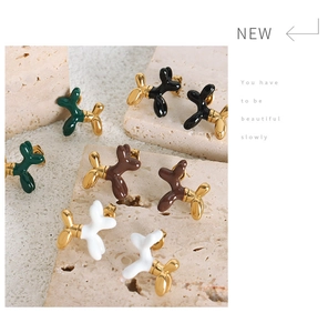 Detailed view of colorful balloon dog stud earrings with glossy enamel and gold plating