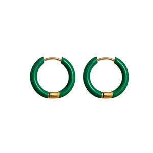 Detail view of gold earrings with green enamel finish and secure hinge closure mechanism