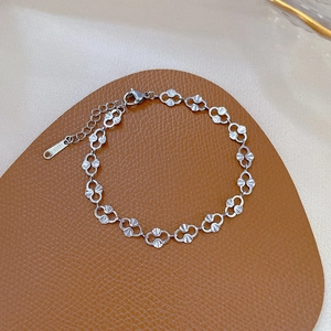 Macro shot of silver stainless steel fan-shaped link chain bracelet with lobster clasp