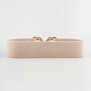 Detailed view of beige elastic wide waist belt with elegant gold-tone metal buckle