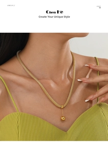 Detail of 14K gold mesh necklace featuring a polished solid ball pendant on a model