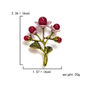 Detailed view of floral brooch with gold branch and purple petals including dimensions