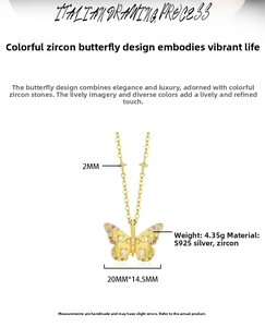 Detail of S925 silver butterfly pendant with colorful zircons and golden necklace chain