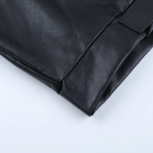 Close-up detail of smooth black leather texture and premium stitching on women jacket