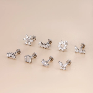 G23 titanium flat back studs set featuring crown, butterfly, and flower zircon designs