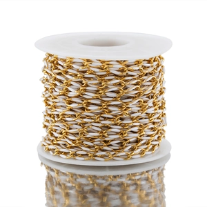 Macro shot of 3.7mm gold and white drip oil chain on a plastic spool for DIY jewelry