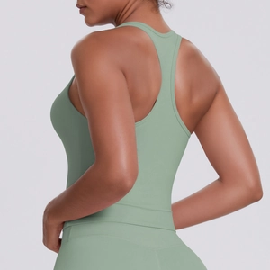 Side-back view of sage green racerback sports top with high-stretch yoga fabric