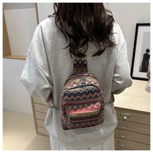 Detail view of colorful bohemian geometric woven texture on a versatile canvas mini backpack