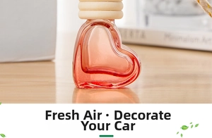 Macro shot of heart-shaped glass perfume bottle with wooden cap on a minimalist desk