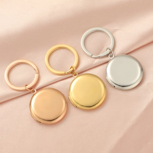 Detailed view of three polished 316L stainless steel photo lockets in gold, silver and rose gold