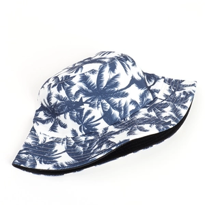 Detailed view of stitching and tropical blue palm tree print on a white bucket hat
