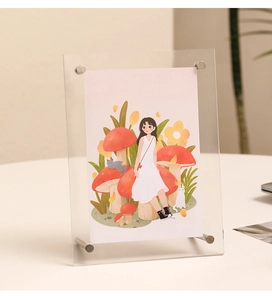 Close-up of clear acrylic picture frame with silver metal screws and colorful art insert