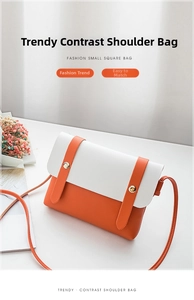 Detail of trendy contrast shoulder bag in white and orange PU leather with dual straps