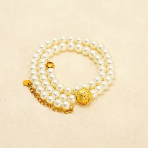 Elegant double-layered pearl necklace with 18K gold-plated bead and adjustable chain